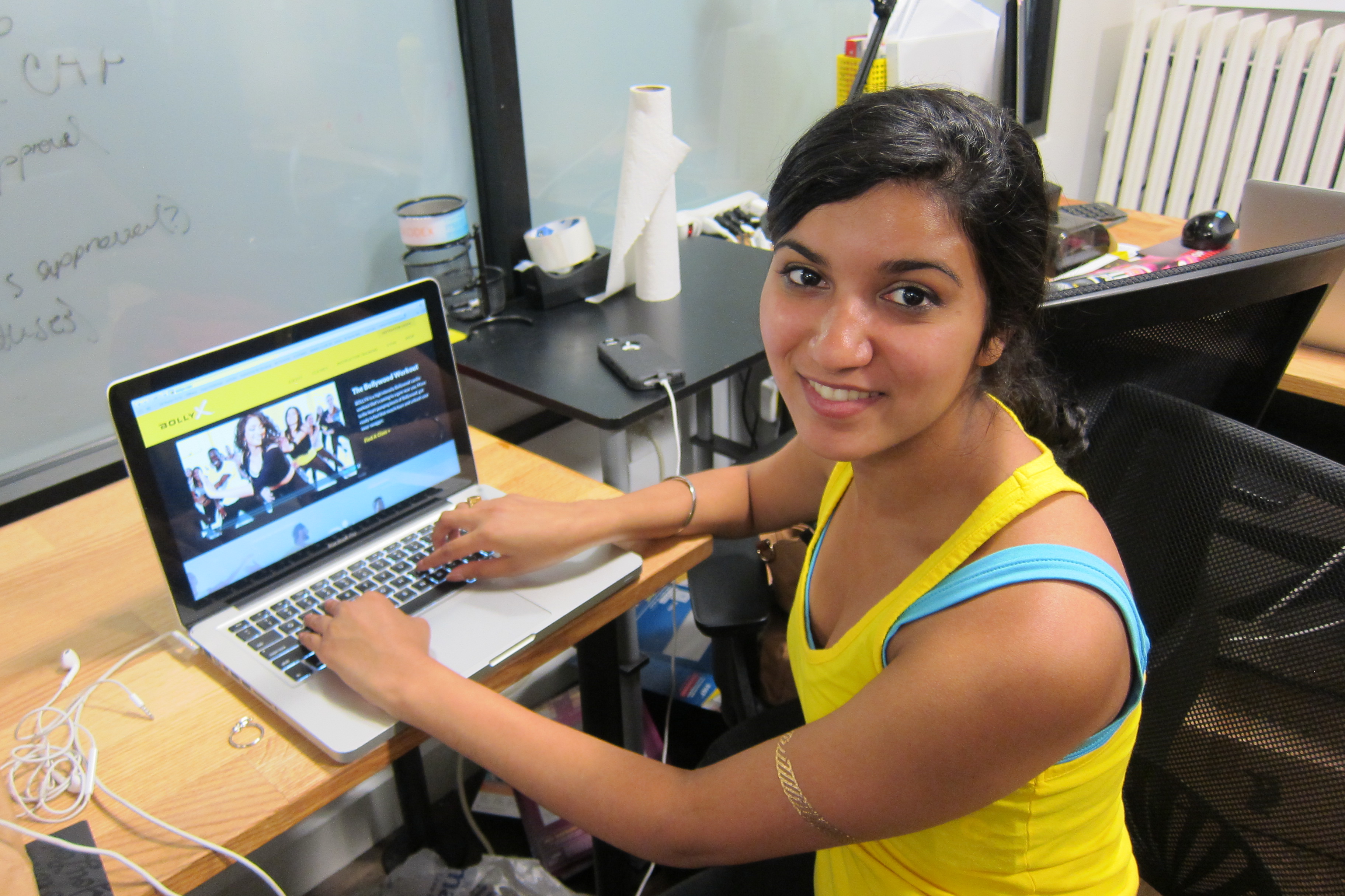 Meha Sadana working at her desk at BollyX headquarters in NYC